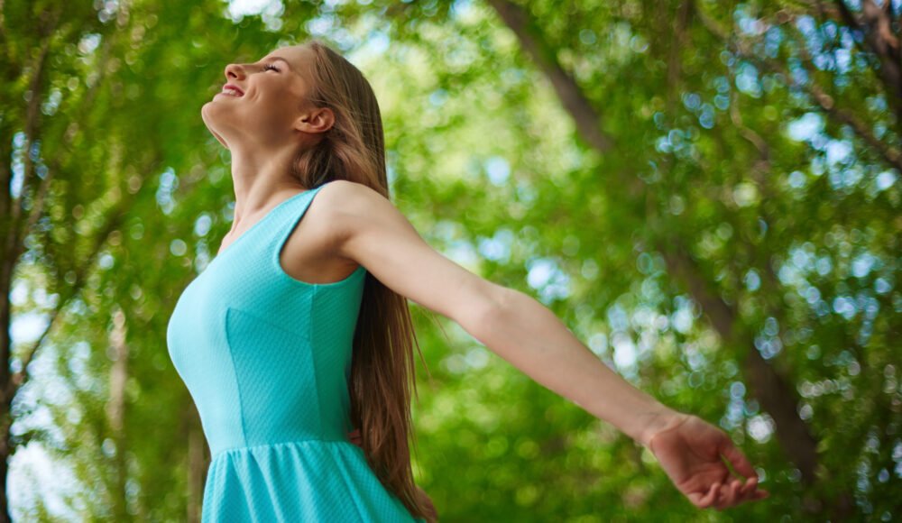 Photo of happy girl taking pleasure in summer day outside